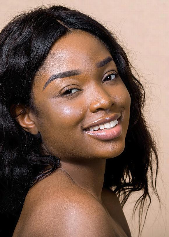 Smiling woman with straightened sew-in hair